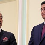 Malaysia’s Prime Minister Muhyiddin Yassin looks at Minister of International Trade and Industry Azmin Ali, during a news conference in Putrajaya